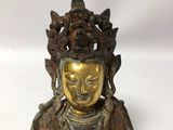 an antique bronze statue of a person holding a bird