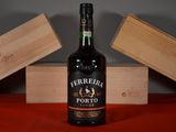 a bottle of wine sitting on a table next to two wooden boxes