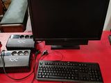 a computer desk with a keyboard, monitor, speakers and a mouse