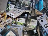 a pile of ink cartridges on a table in a store