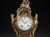 an image of a gold clock sitting on top of a table