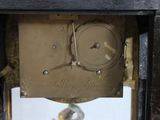 a clock that is sitting in the corner of a room