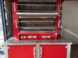 a red oven that is sitting on a pallet