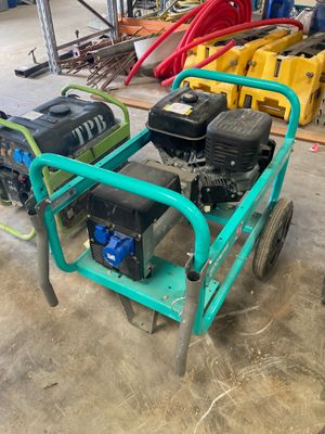 a small green cart with a water pump on it