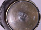 a close up view of a metal object on a white surface