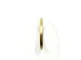 a close up of a gold ring on a white surface