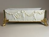 an image of a white and gold tray with figures on it
