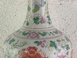 a vase with a dragon on it sitting on a table