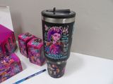 a cup that is sitting on a table next to other items