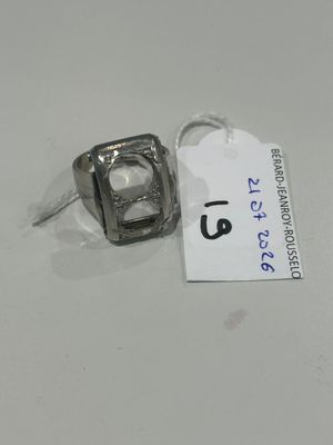 a ring that is sitting on a table with a price tag