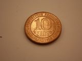an image of a ten cent coin on a white surface