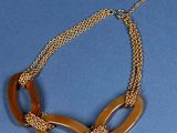 necklace made of wood and gold chain on a blue background