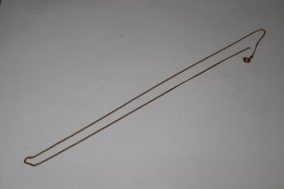 a long gold necklace with a long chain attached to it