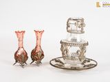 two vases and a saucer sitting on a table