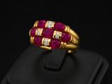 a close up of a gold ring with ruby and diamonds
