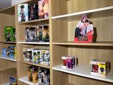 many shelves with various items on them in a room