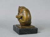 bronze figurine of a sleeping cat on a marble base