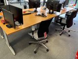a desk with two computer monitors and a keyboard on it