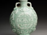 chinese celade glass snuff bottle with a design on the lid