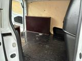a white van with the door open on a rainy day