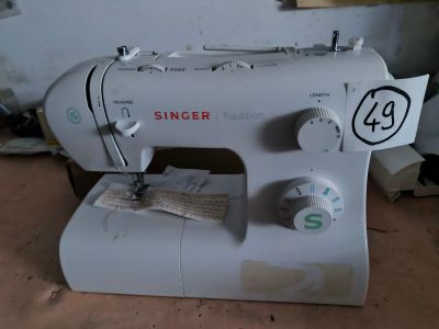 a white sewing machine sitting on a table in a room