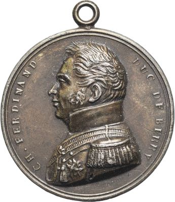 a close up of a medal with a man ' s face on it