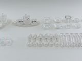 several pieces of clear plastic are arranged on a white surface