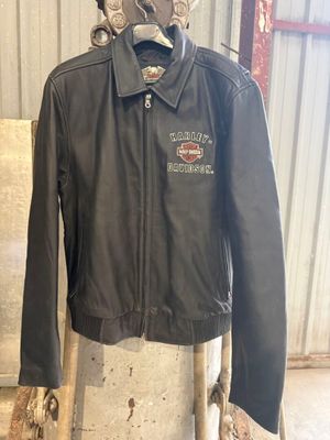 leather motorcycle jacket on a mannequin stand in a garage