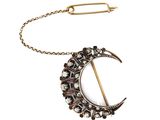 a close up of a broochle with a chain around it
