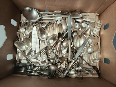 a box full of silver spoons and spoons in it