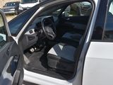 a white car with its door open next to a white car