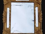 an image of a gold framed mirror on a black background