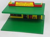 a green shelf with a yellow and red sign on it