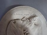 a statue of a man with a beard on a plate