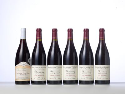 six bottles of wine lined up in a row on a table