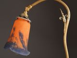 an orange and blue lamp that is on top of a wooden pole