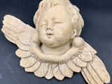 a statue of an angel with wings on a black surface