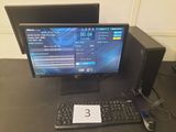 un ordinateur de bureau posé sur une table avec un clavier et une souris