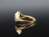 a close up of a gold ring with diamonds on a black surface