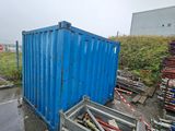 a blue container sitting in the middle of a parking lot