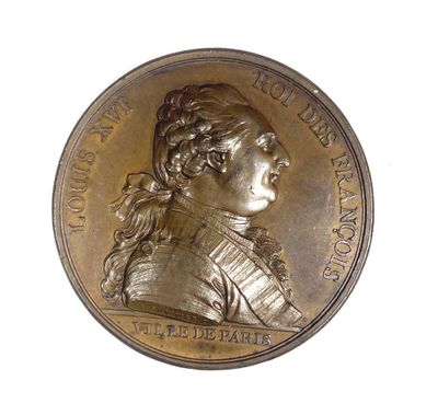 an image of a bronze medal with a woman ' s face on it