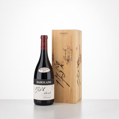 the bottle of red wine is next to a wooden box
