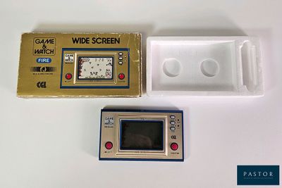 a game and a watch sitting next to each other on a table