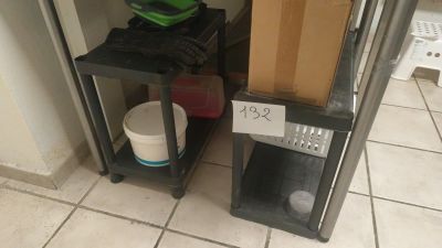 a box and a bucket sitting on a shelf in a room