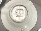 a white plate with a picture on it sitting on a table
