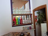 a kitchen with a table and a refrigerator in it