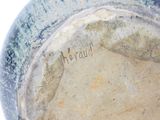 a close up of a blue vase with writing on it