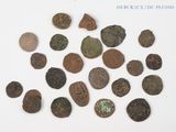 some old coins are scattered together on a white surface
