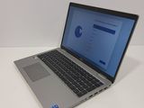 a laptop computer sitting on a table with a blue screen