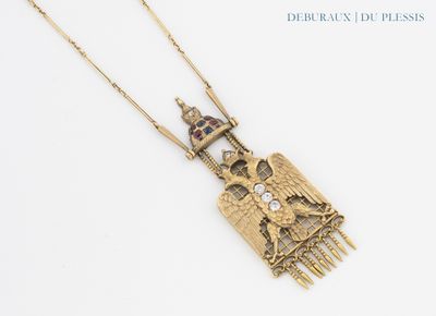 gold plated necklace with a bird, castle, and castle on a chain